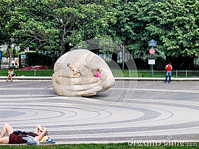 Children crawl on a Listener sculpture Editorial Stock Photo