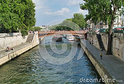 PARIS, FRANCE - JULY 2014: Exterior view Seine River along Notre Dame with tourists and Bateau Mouche. This is the most visited Editorial Stock Photo