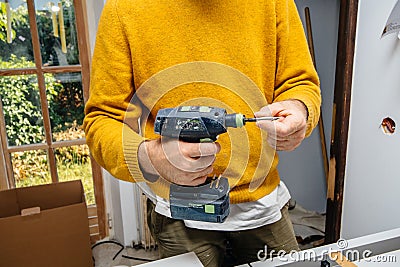 Male worker holding in hand Cordless drill T 18 plus 3 C 3,1-Plus Editorial Stock Photo