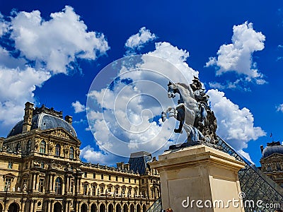 Paris, France, June 2019: Louvre Museum and Louis XIV statue Editorial Stock Photo