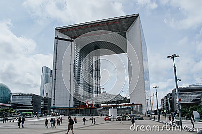 PARIS, FRANCE - JUNE 27, 2016: People walk in front of Grand Arche in La Defense, commercial, business district of the city. Urban Editorial Stock Photo