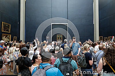 Tourists crowd to take photos of the famous Mona Lisa painting of Leonardo da Vinci inside the Louvre museum Editorial Stock Photo