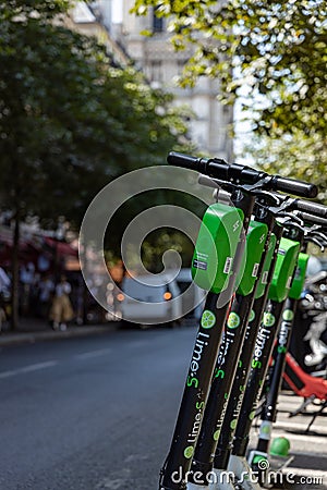 Paris, FRANCE - June 27, 2019: View of Lime electric scooters, rented through a mobile app and dropped off anywhere in the French Editorial Stock Photo