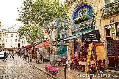 Paris, France - 24.04.2019: Latin Quarter. Narrow street of Paris among old traditional parisian houses and cafe in Editorial Stock Photo