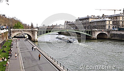 Boat passing under The Pont Notre-Dame on The River Seine. Paris France. March 29, 2023. Editorial Stock Photo