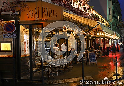 The Cafe Vrai Pars at rainy evening.It is a cafe in the Montmartre, Paris, France. Editorial Stock Photo