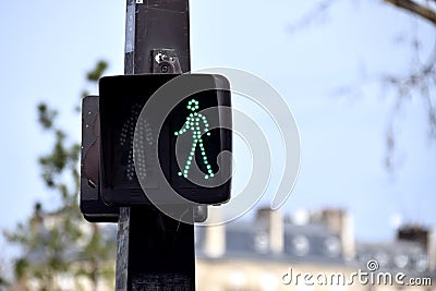 Green Stop Go Crossing Man with blue sky Behind. Paris, France. March 29, 2023. Editorial Stock Photo