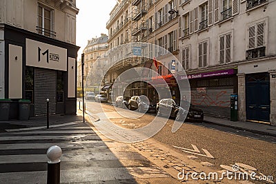 Paris, France, March 27, 2017: View on narrow cobbled street among traditional parisian buildings in Paris, France. Editorial Stock Photo