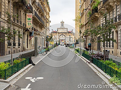 Paris, France - May 11th 2023: Recently redesigned street with green spaces and bicycle stations Editorial Stock Photo