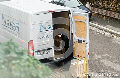 Man unloading goods from white delivery van Editorial Stock Photo