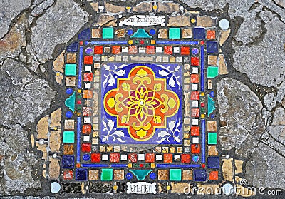 Closeup of mosaic created by french street artist Ememem incorporated in cracked sidewalk in front of Notre Dame square Editorial Stock Photo