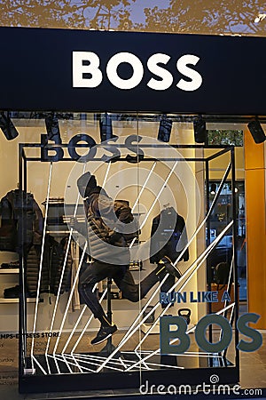 Closeup of store display window with logo lettering of Boss fashion label Editorial Stock Photo