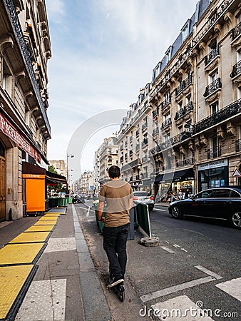 Man on electric scooter in France Editorial Stock Photo