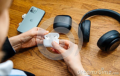 Woman testing latest Apple Computers AirPods Pro headphones Editorial Stock Photo