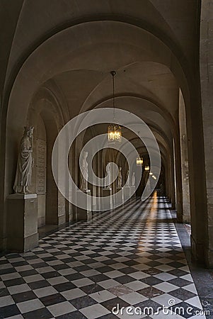 Vertical shot of empty corridor with statues in the Castle of Versailles in Paris, France Editorial Stock Photo