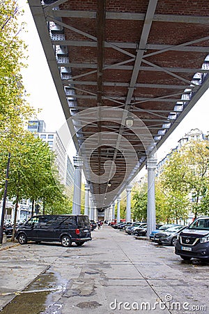 Modern street in Paris, France. Car parking under the railway bridge Editorial Stock Photo