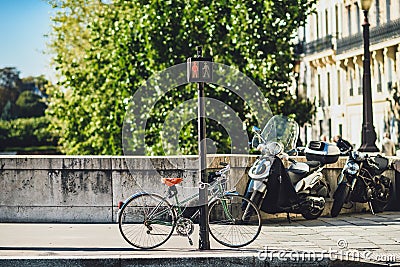 Parked bicycle and motorbikes in the Paris center, France Editorial Stock Photo