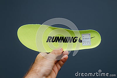 POV male hand holding sport shoe running sole from Nike Sport Wear Editorial Stock Photo