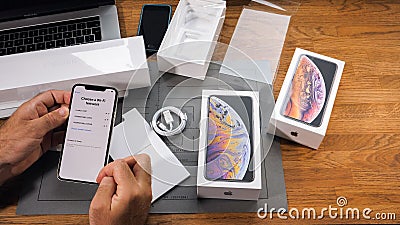 Man unboxing iPhone Xs Max Xr choose, wi-fi, network, Editorial Stock Photo
