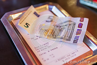 Paris, France, 10/09/2019: Tipping in euros at a cafe. Close-up Editorial Stock Photo
