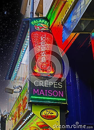 Closeup of neon lights with advertising for french falafel, kebab and crepes street food Editorial Stock Photo