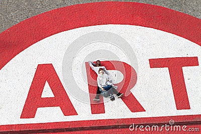 People at Centre Pompidou over art sign Editorial Stock Photo