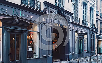 Parisian architecture and historical buildings, restaurants and boutique stores on streets of Paris, France Editorial Stock Photo