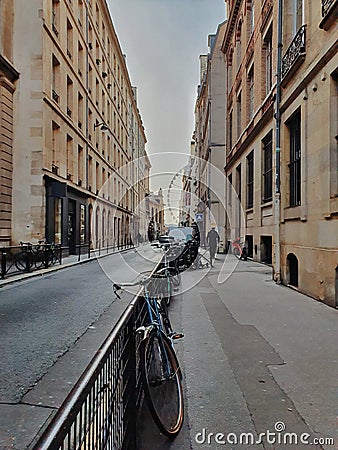 Parisian street, view of a small road and the haussmannian building in Paris center, France Editorial Stock Photo