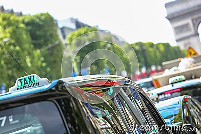Parisian taxi on avenue des champs-elysees, with the Arc de Trio Stock Photo