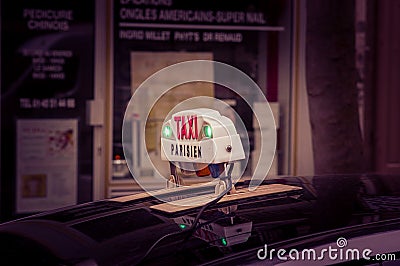 Parisian taxi sign with green light on, France Editorial Stock Photo