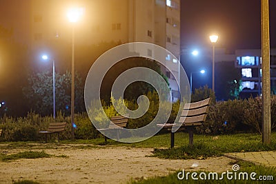 Park Bench in the City. Serene Nocturnal Urban Escape. Stock Photo