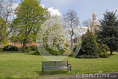 Park bench in spring with Church in background, Greenwich, England Stock Photo