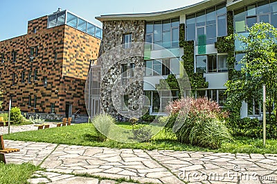 Park with benches around the academic buildings of the International College, in Dilijan surrounded by a reserved forest Editorial Stock Photo