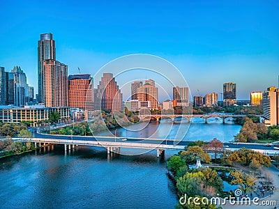 Park and bridges over the Colorado River near the Austin, Texas cityscape during sunset Stock Photo