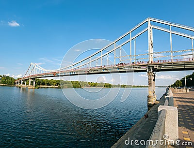 Park pedestrian bridge across the Dnipro River to Trukhanov Island Editorial Stock Photo