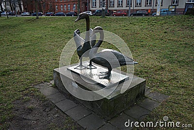 Park recreation area with decorative figures of swans near the river Spree. 12555 Berlin, Germany Editorial Stock Photo