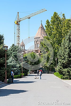 Armenia, Echmiadzin, September 2021. Repair of the main temple of the monastery, people and a dog. Editorial Stock Photo