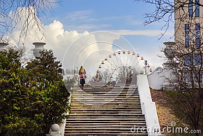 Park in spring. Against the backdrop of a beautiful staircase, a Ferris wheel Editorial Stock Photo