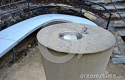 In the park there is a path through the terraces with sage and railings forged into the shape of waves and arches. arch bench and Stock Photo