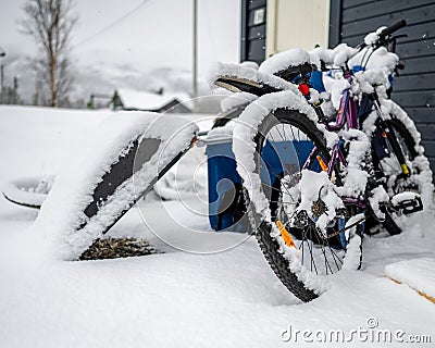 Parked bicycle covered in sn Editorial Stock Photo