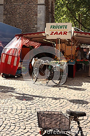 Parked bicycle by street market, Cologne, Germany Editorial Stock Photo