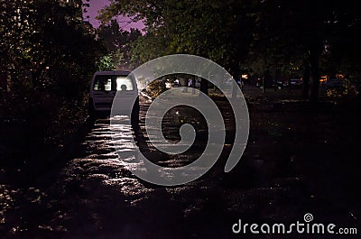 Parked car at night city under rain. Stock Photo