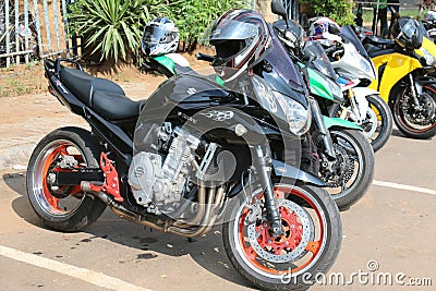 Parked motorbikes at Yearly Mass Ride with Black Suzuki Racing Editorial Stock Photo