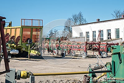 Parking agricultural machinery and harvest. rows of plows, cultivators, bodies Stock Photo