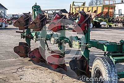 Parking agricultural machinery and harvest. rows of plows, cultivators, bodies Stock Photo