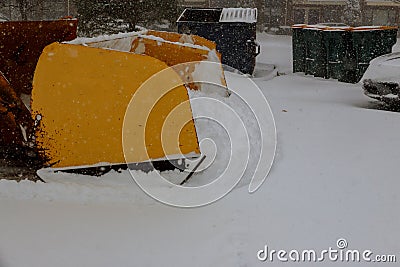 Parking for cars snow removal by tractor Stock Photo