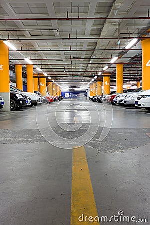 Parking garage, underground interior with a few parked cars Stock Photo