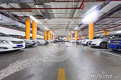 Parking garage, underground interior with a few parked cars Stock Photo