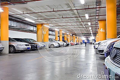 Parking garage, underground interior with a few parked cars Stock Photo