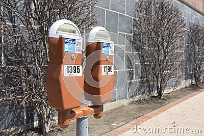 Parking meters along a sidewalk Editorial Stock Photo